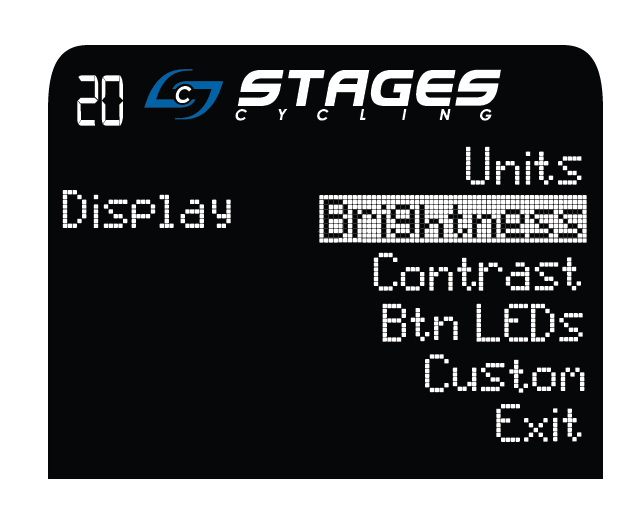 La pantalla de la consola muestra 'mostrar' a la izquierda y 'unidades, brillo, contraste, LED de botones, personalizar y salir' a la derecha, con la palabra 'brillo' resaltada.